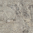 Close-up of 6x6 Silver Travertine tile showing tumbled texture and rounded edges