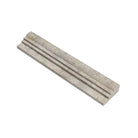 Close-up of OG2 molding profile showing double-step edge and honed surface in silver travertine