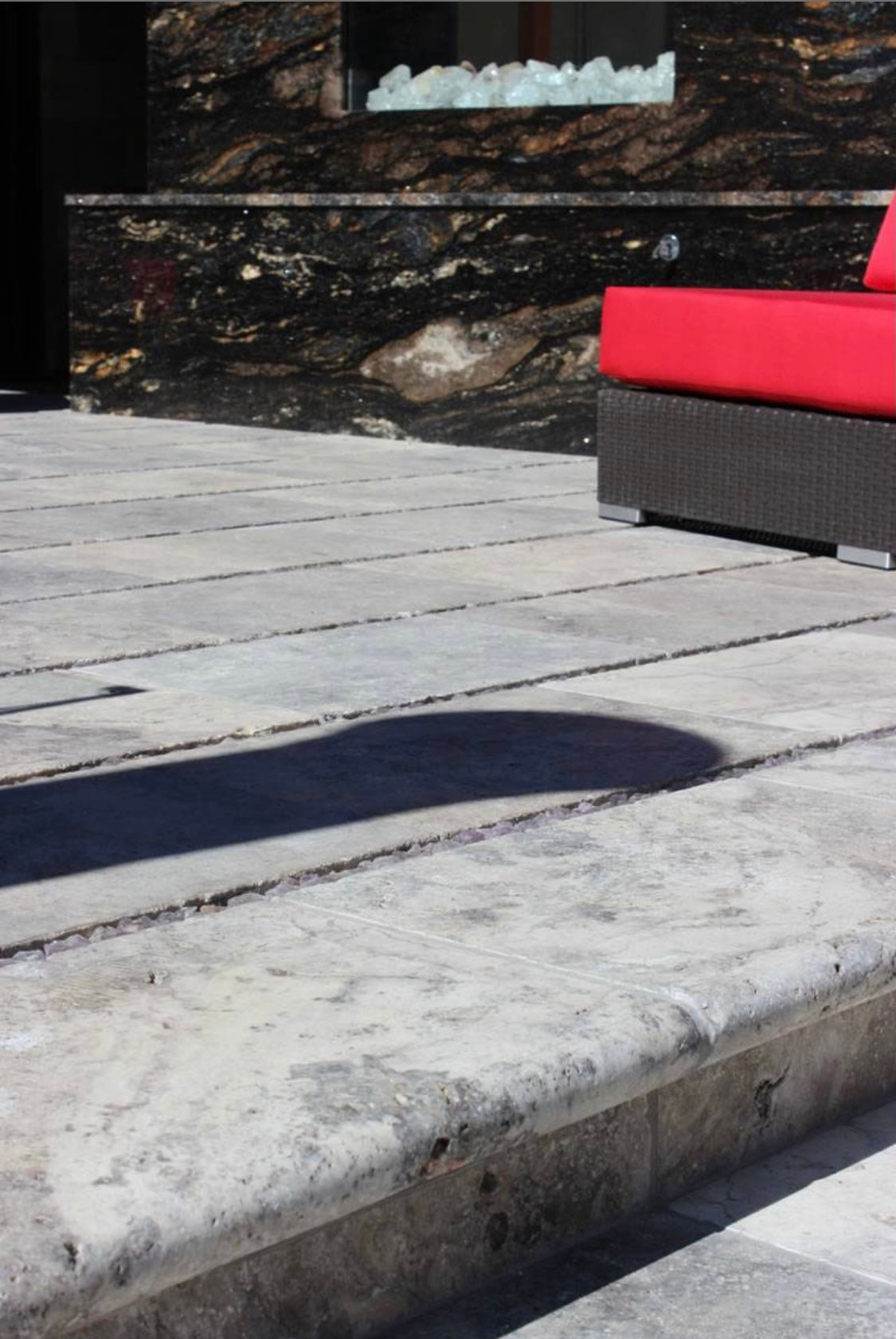 Silver Travertine Pool Coping installed on pool edge with coordinating pavers