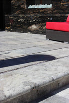Silver Travertine Pool Coping installed on pool edge with coordinating pavers