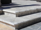 Silver Travertine Pool Coping installed on pool edge with coordinating pavers