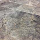 Close-up of Silver Travertine showing brushed texture and chiseled edge detail