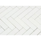 Close-up of Thassos White Herringbone pattern showing 1x4 marble tiles