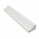 Close-up of Thassos White marble crown molding showing polished surface and edge profile