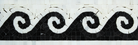 Close-up view of black wave on white marble border tile