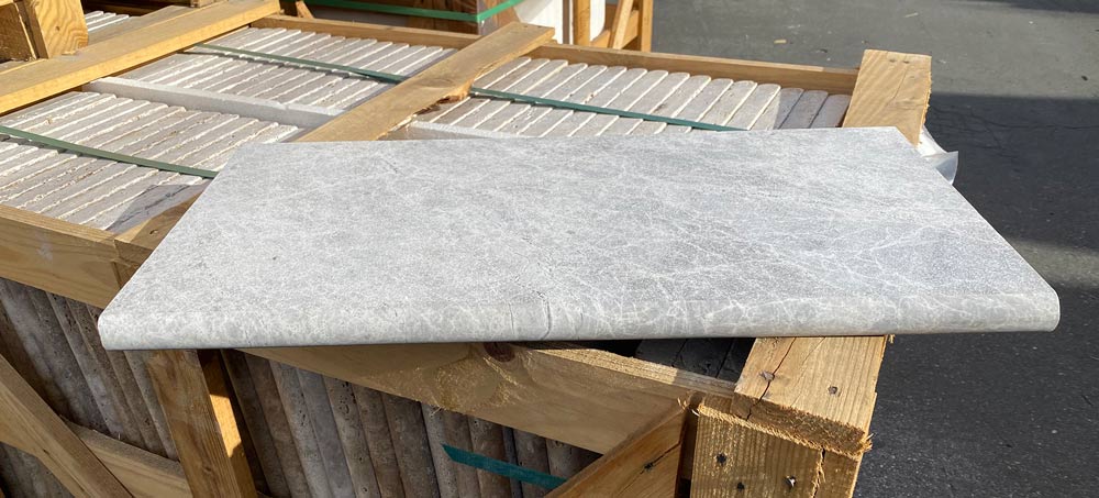 Close-up of bullnose edge detail on Tundra Grey marble coping