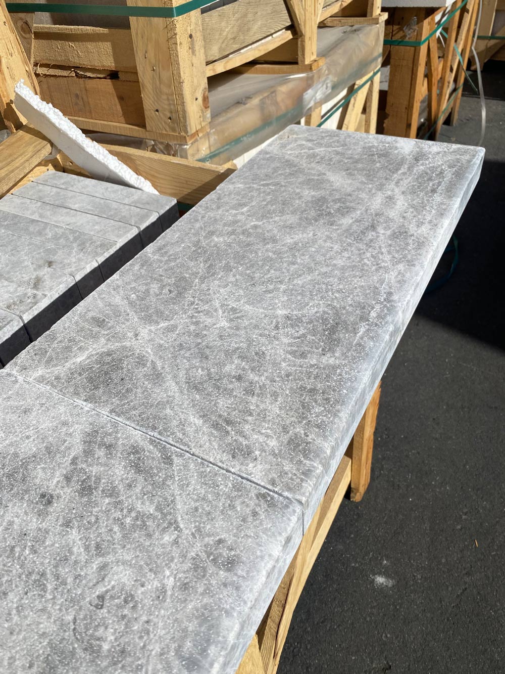 Close-up of modern edge profile and veining in Tundra Grey marble coping