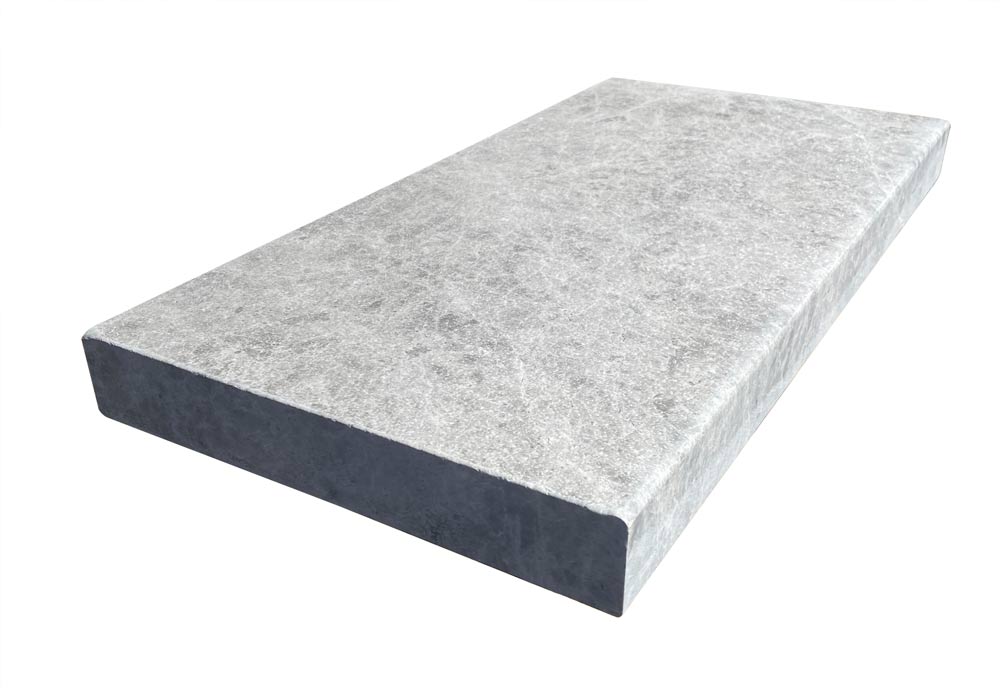 Flat lay of Tundra Grey Marble Pool Coping with bullnose edge and tumbled finish