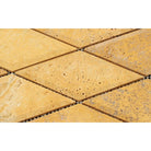 Close-up of Tuscany Gold 3x6 mosaic showing beveled edge and warm natural tones