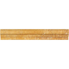 Close-up of 2x12 travertine chair rail molding showing honed finish and warm gold veining