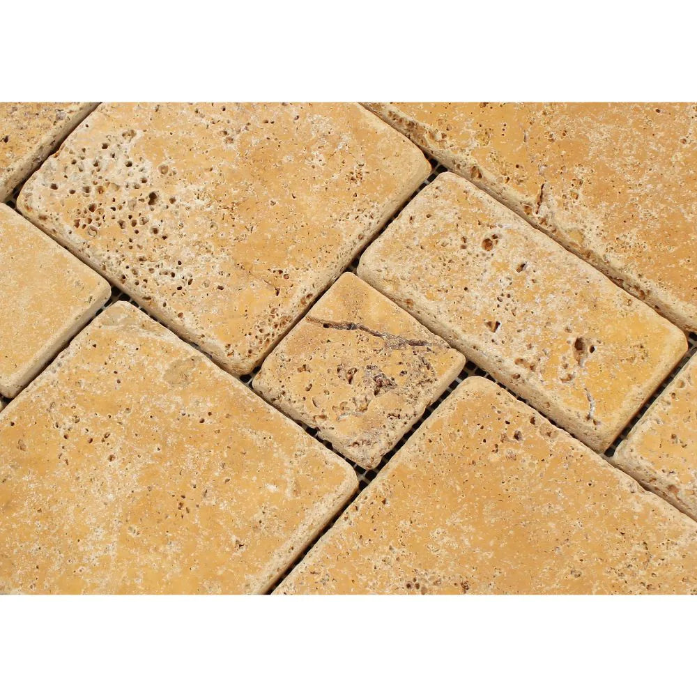 Close-up of tumbled travertine opus mosaic showing varied shapes and natural color tones