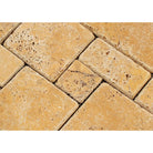Close-up of tumbled travertine opus mosaic showing varied shapes and natural color tones