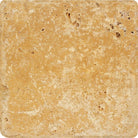Close-up of Tuscany Gold Travertine tile with tumbled edge and textured surface