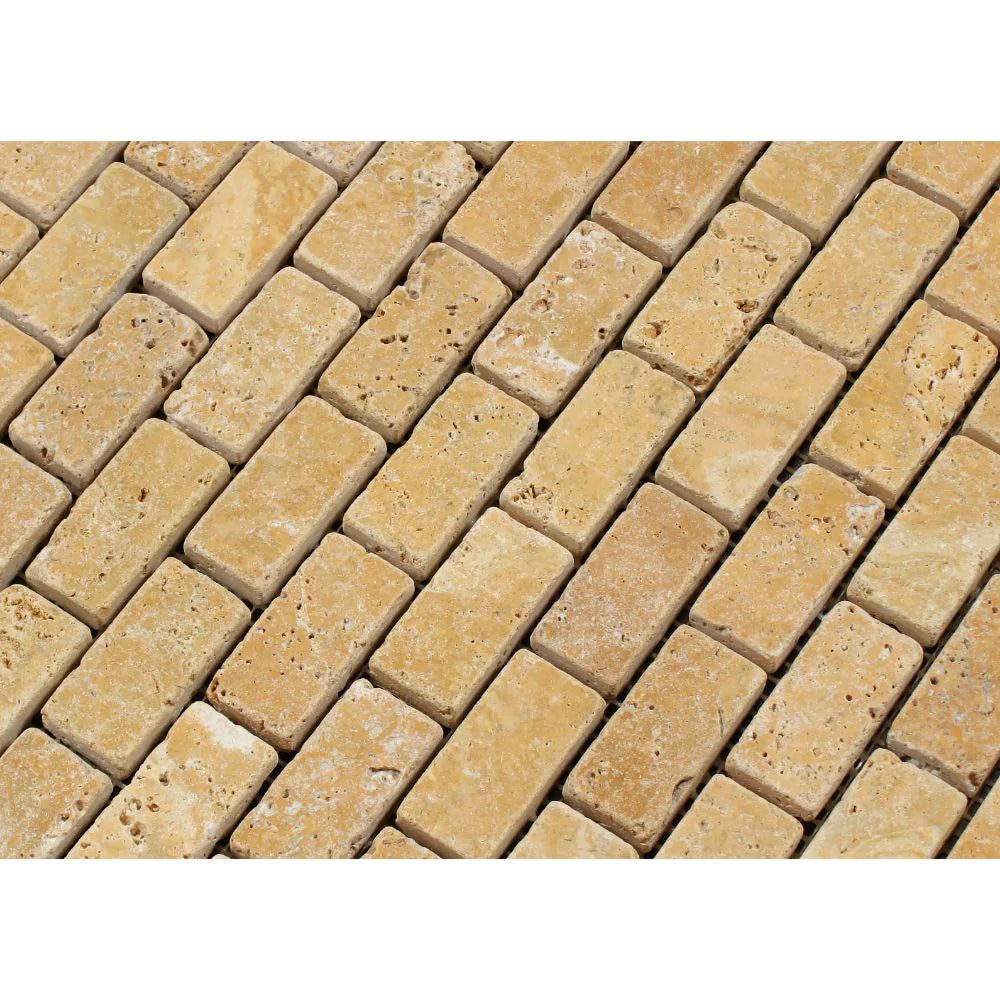 Close-up of 1x2 tumbled travertine in Tuscany Gold color blend