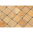 Close-up of Tuscany Gold 2x2 travertine mosaic showing natural stone variatio