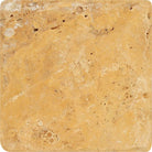 Close-up of 4x4 Tuscany Gold Travertine tile showing tumbled edges and surface variation