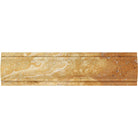 Close-up of arched Tuscany Gold molding showing honed surface and warm tones