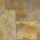 Close-up of Tuscany Gold travertine showing brushed surface and chiseled edge detail