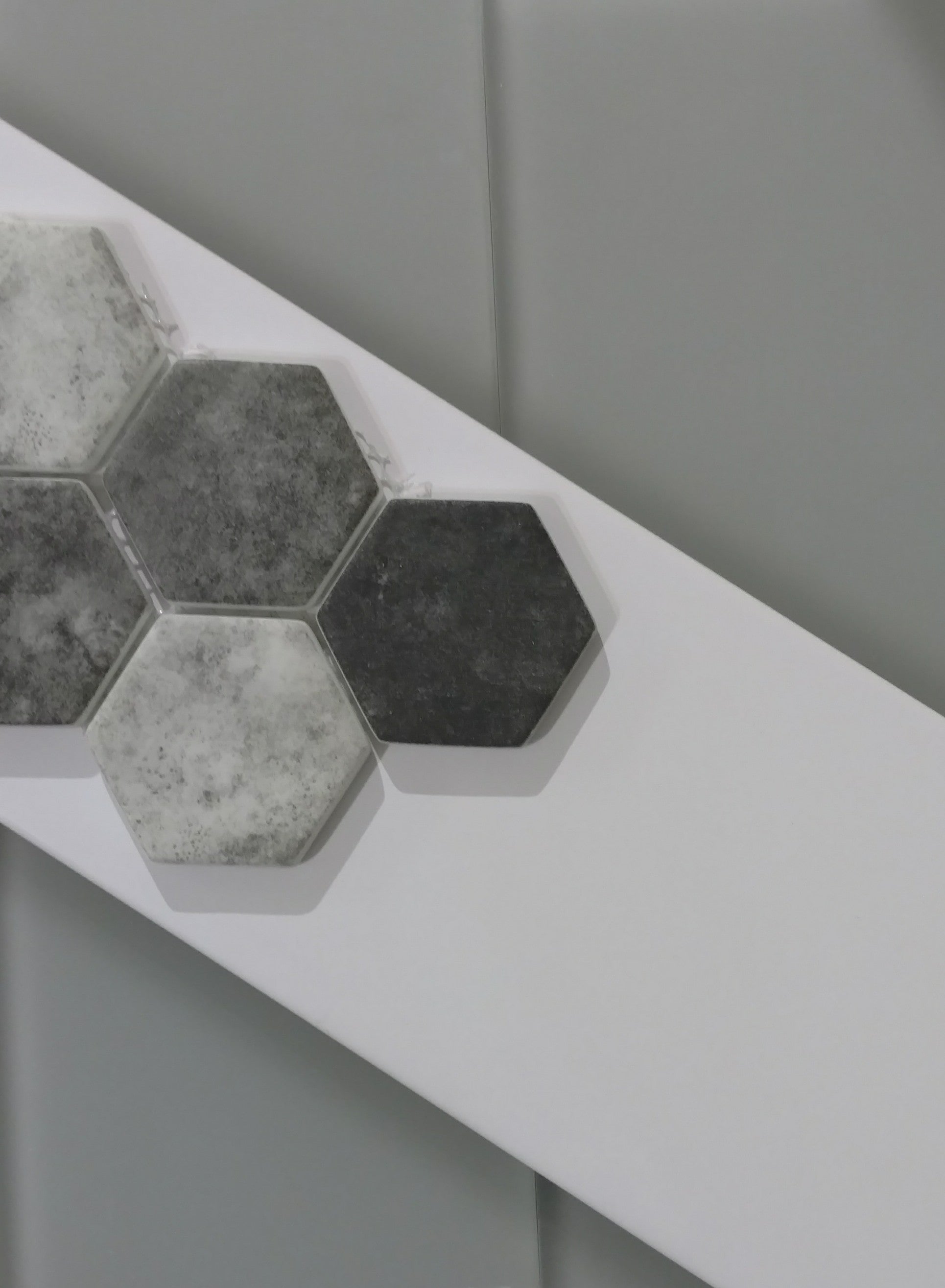 Close-up of Urban Tapestry Mosaic showing recycled glass 2-inch hexagon chips with modern neutral hues