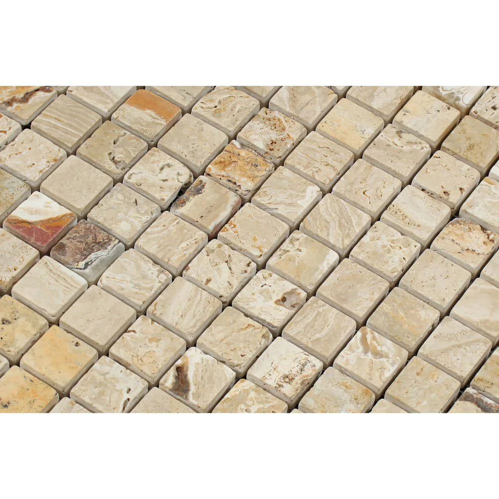 Close-up of 1x1 tumbled travertine mosaic showing rounded edges and warm natural variation