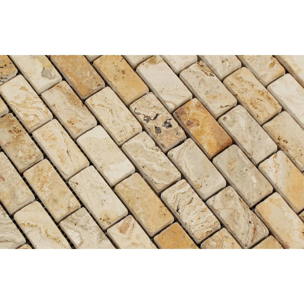 Close-up of 1x2 tumbled travertine bricks showing soft edges and rustic tones