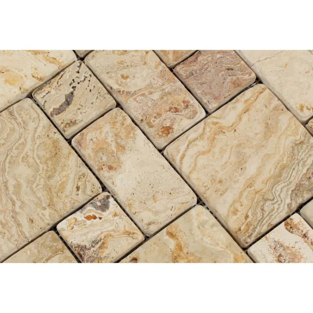 Close-up of tumbled Valencia Travertine showing warm rust, cream, and red tones in Mini Versailles pattern