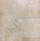 Top view of Warm Walnut Travertine Versailles Pattern tile set with brushed and chiseled finish