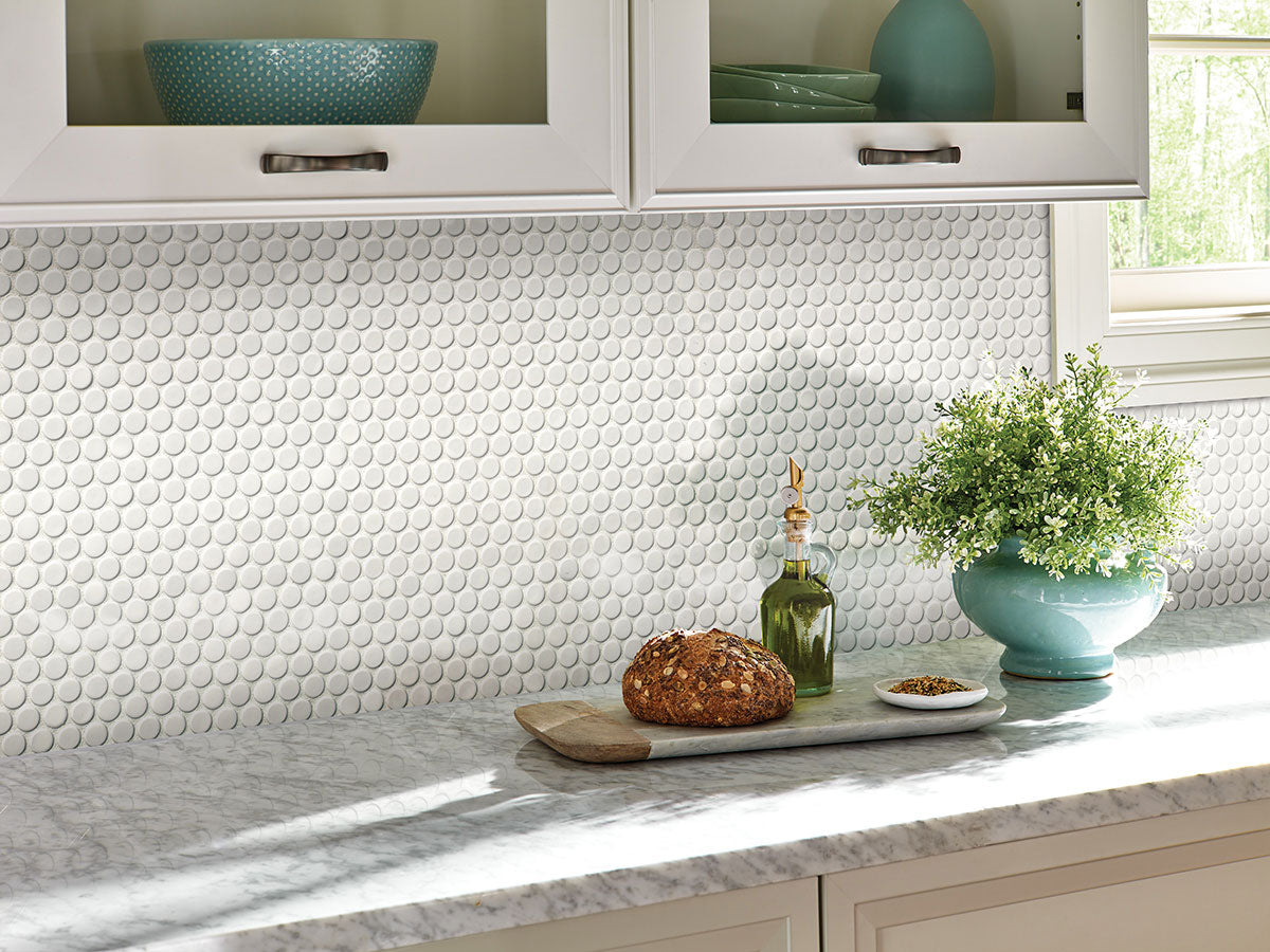 Close-up of porcelain penny round tiles showing smooth glossy surface and circular shape